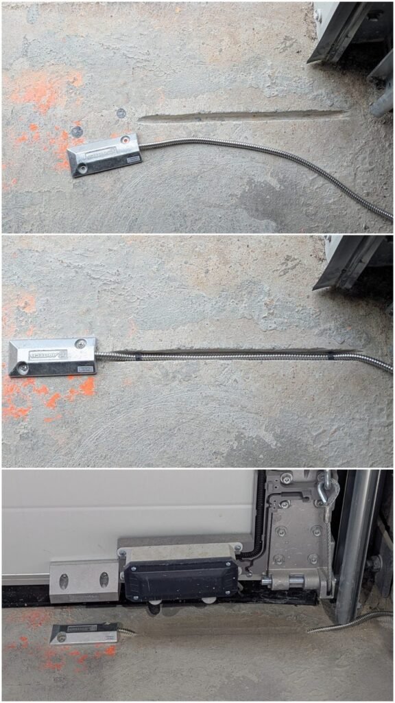 Étapes d'installation d'un contact magnétique d'ouverture sur une porte industrielle, avec protection et intégration du câblage au sol, réalisées par JOUVE SCF.